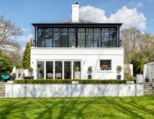 heritage aluminium windows in a conservatory design to a detached white house