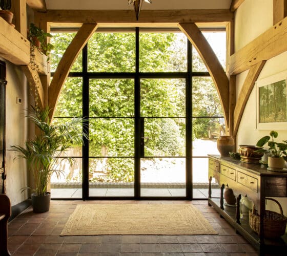 ultra-slim exterior steel-look style doors in a barn conversion hallway