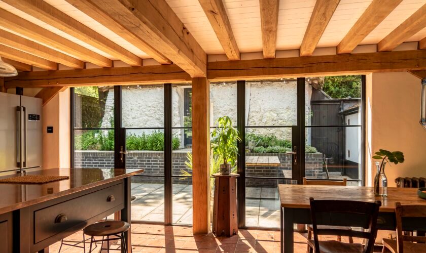 ultra slim steel look exterior doors in a country kitchen with oak beams