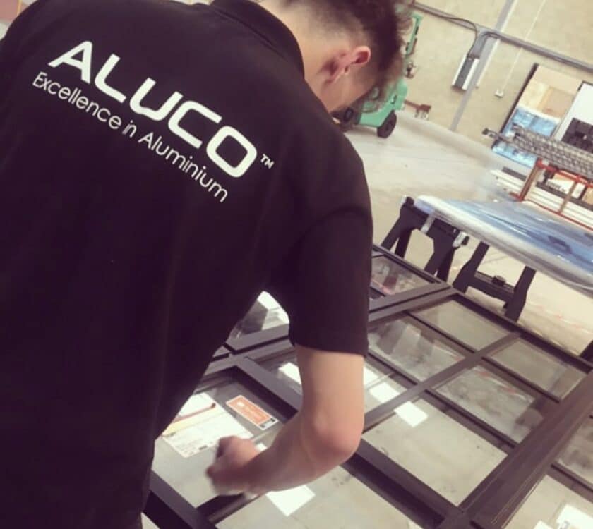 aluco showroom and factory operative measuring a window frame