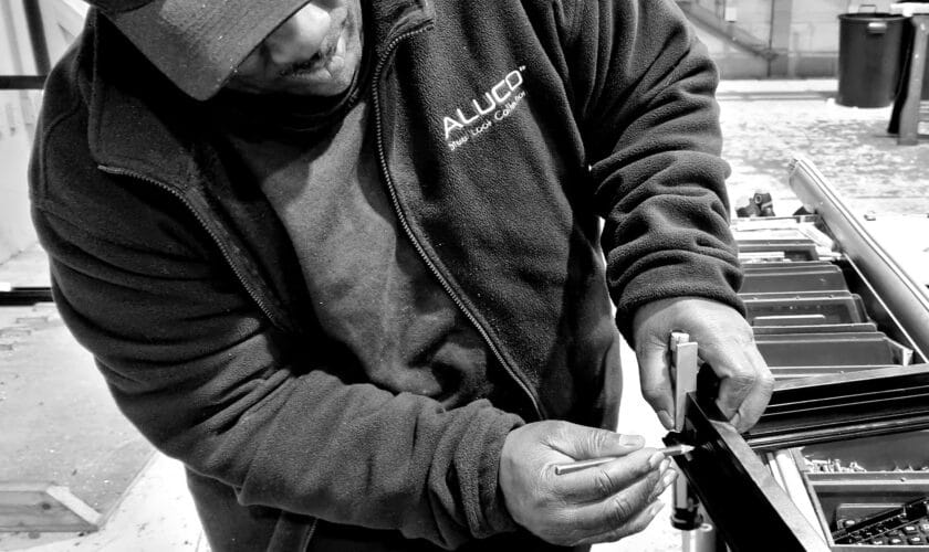 aluco showroom and factory operative measuring a window frame