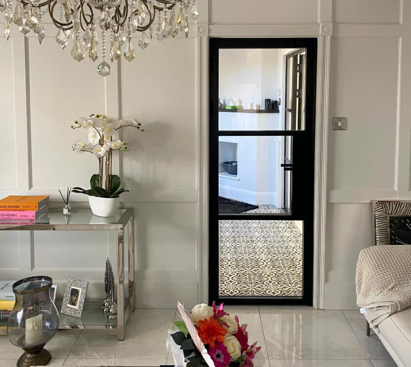 luxury lounge interior with sofa, coffee table and steel-look black door