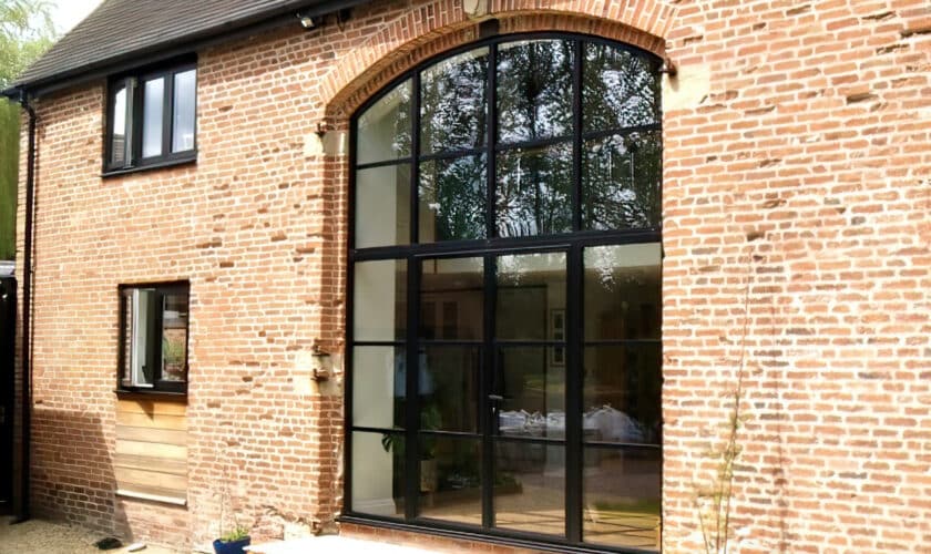 curved heritage doors and window screen in a barn conversion
