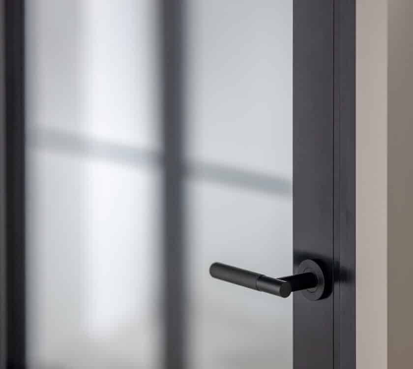 close up view of aluco aluminium internal doors showing the handle and Crittall® style bars