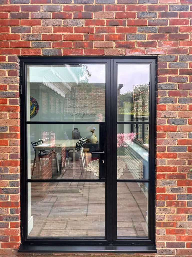 Patio door fitted in a brick opening