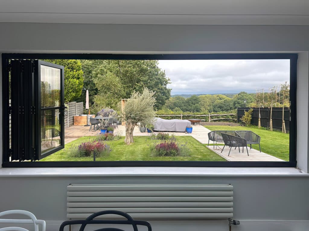 Bifold window open looking out to a garden.