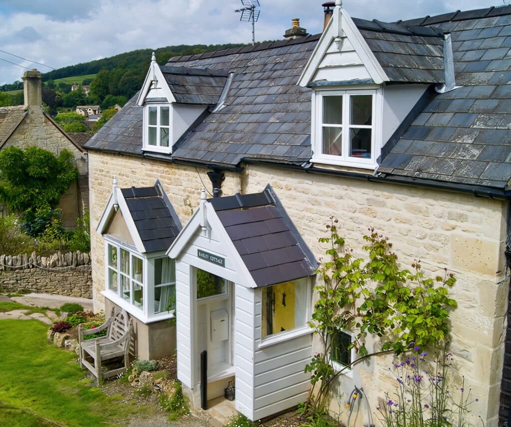 steel look windows in Gloucestershire to a character cottage with hills in the background