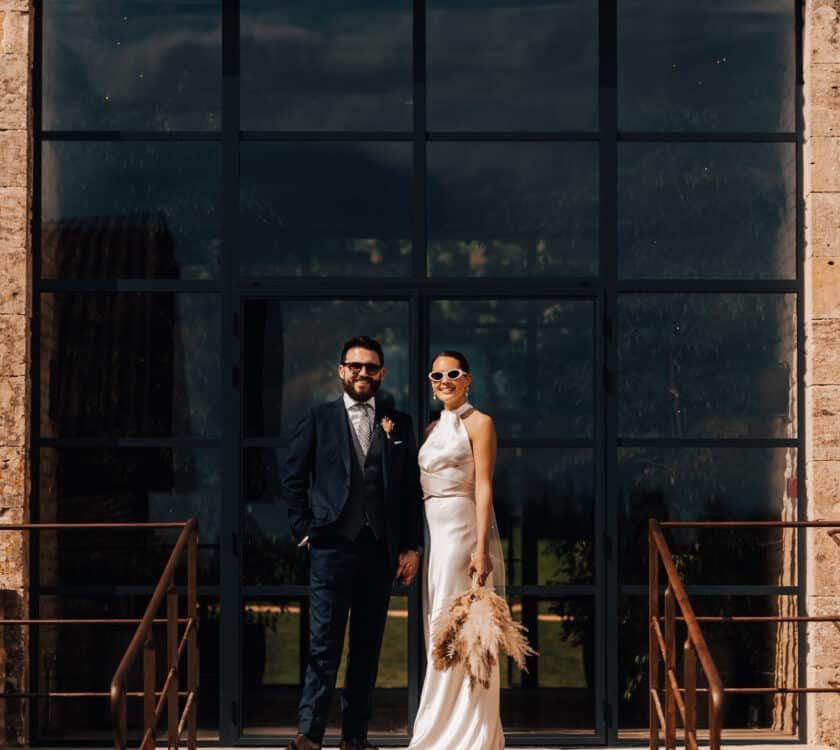picture of a married couple in front of  industrial style barn doors