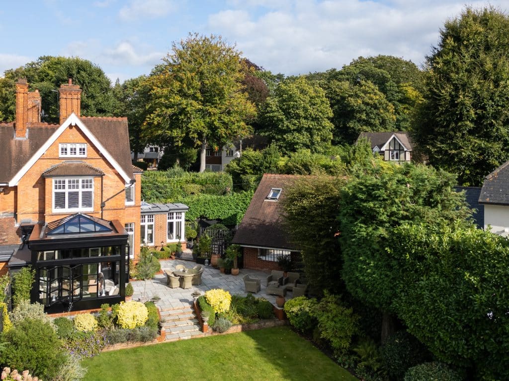 heritage style orangery view from above with Victorian home, green lawn and mature trees