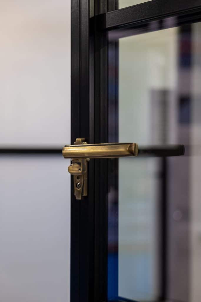 Elite by Aluco close up of window sash and brass handle.