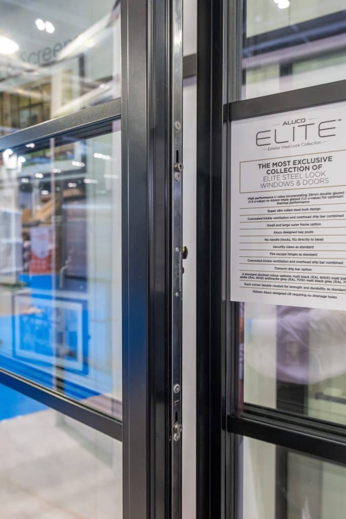 close up picture of Elite by Aluco window showing partialy open sash and product label.