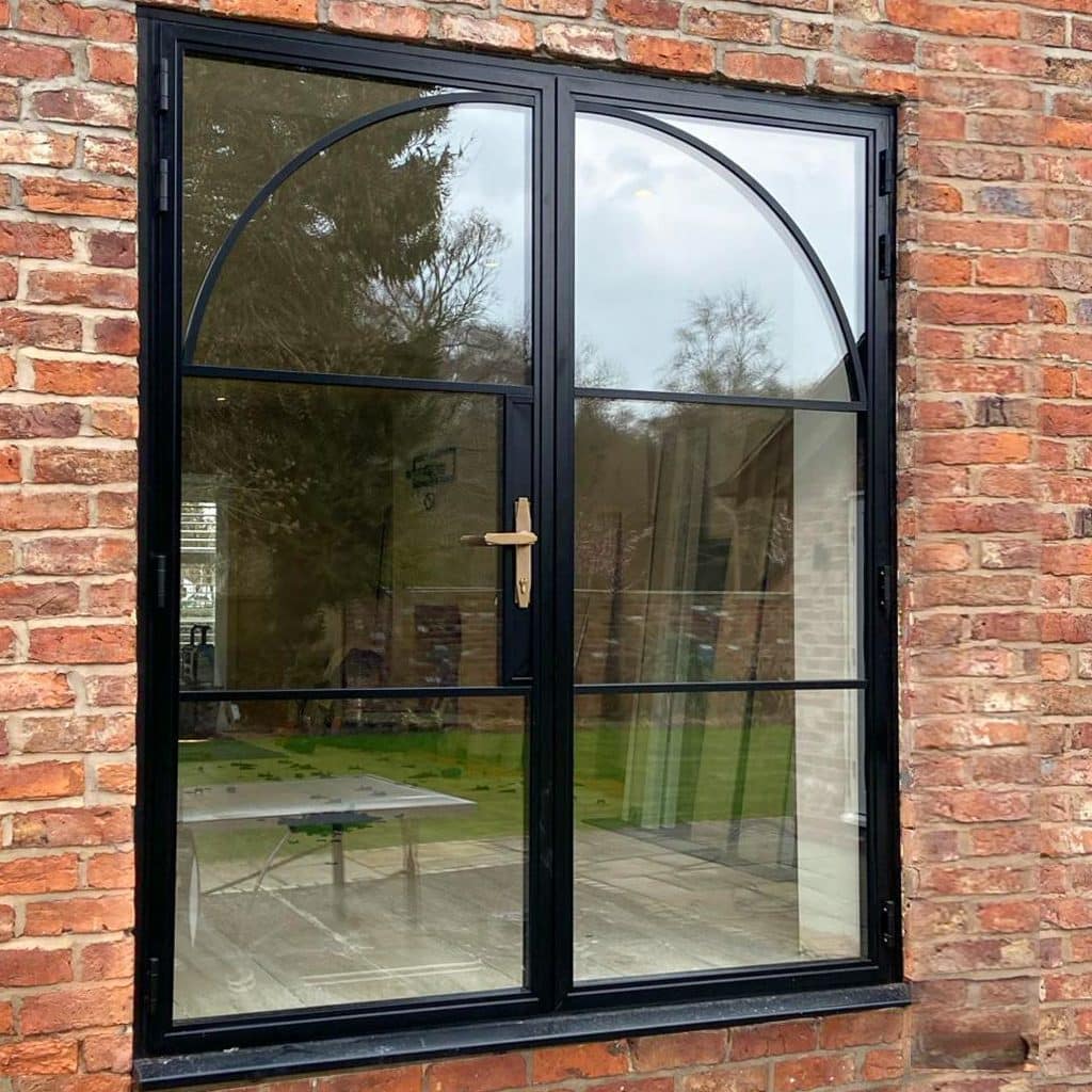 black heritage French doors outside view in brickwork