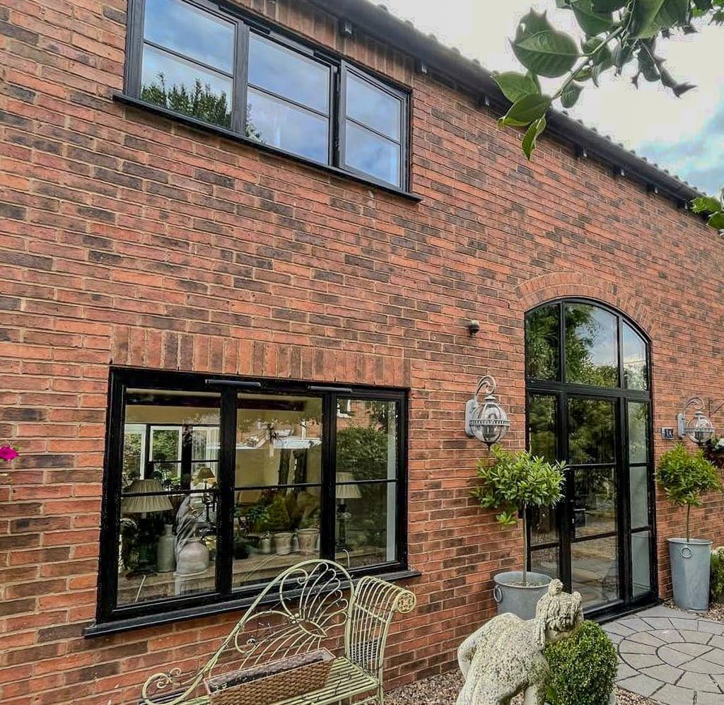 steel look windows in warwickshire barn-style home in black paint