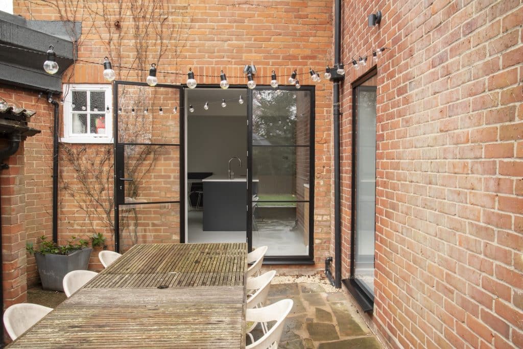 Patio shot with external doors and picture window