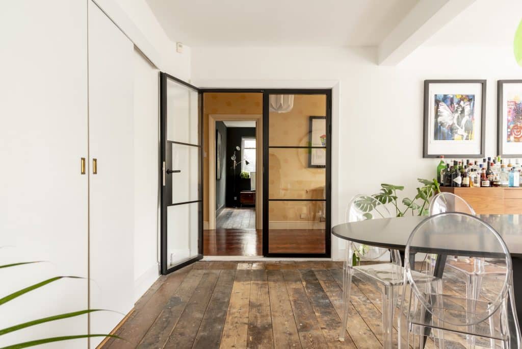 Partiall open black industrial doors in a dining room
