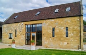 barn conversion showing black slimline windows set in stone