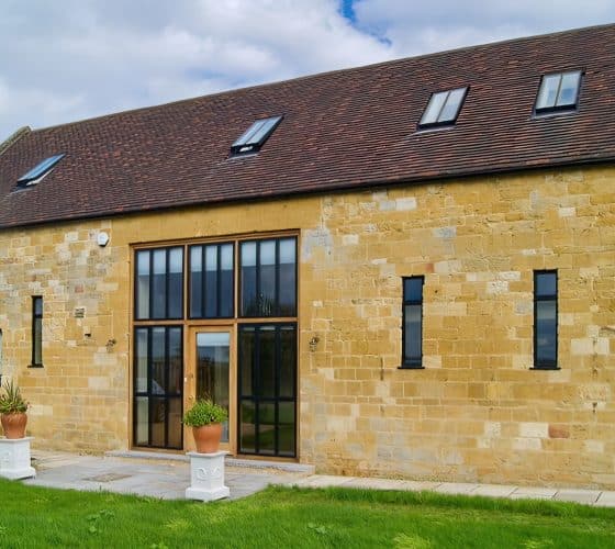 barn conversion showing black slimline windows set in stone