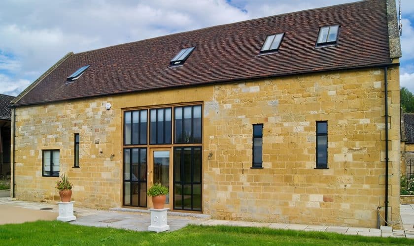 barn conversion showing black slimline windows set in stone