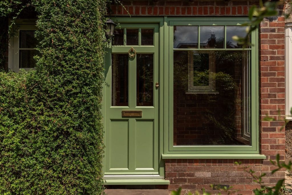 Front door picture of tradition front door in RAL 6016 green with matching side panel.