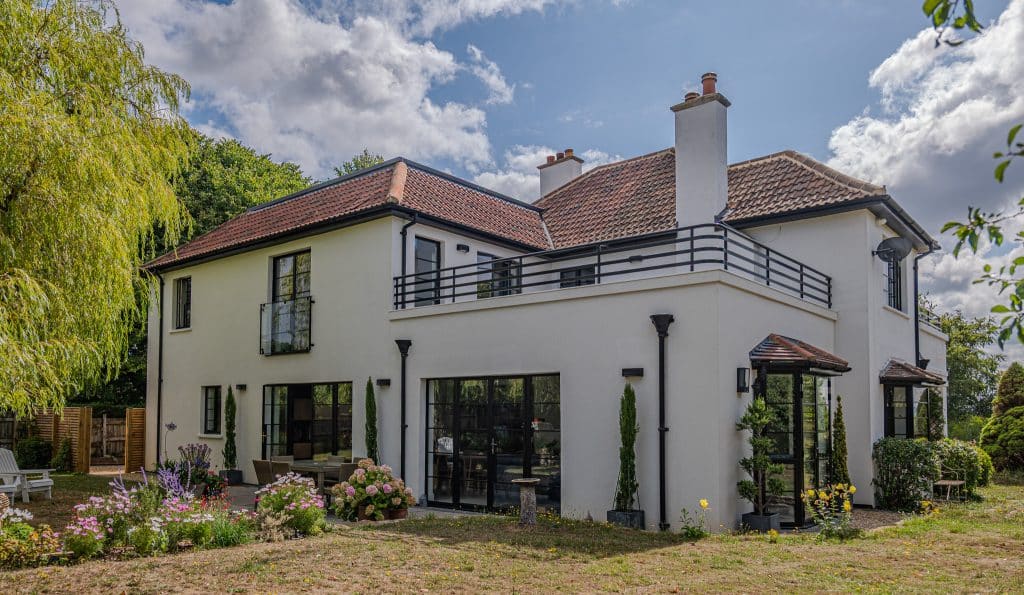 Aluco black steel look windows in an extension with double doors and roof terrace