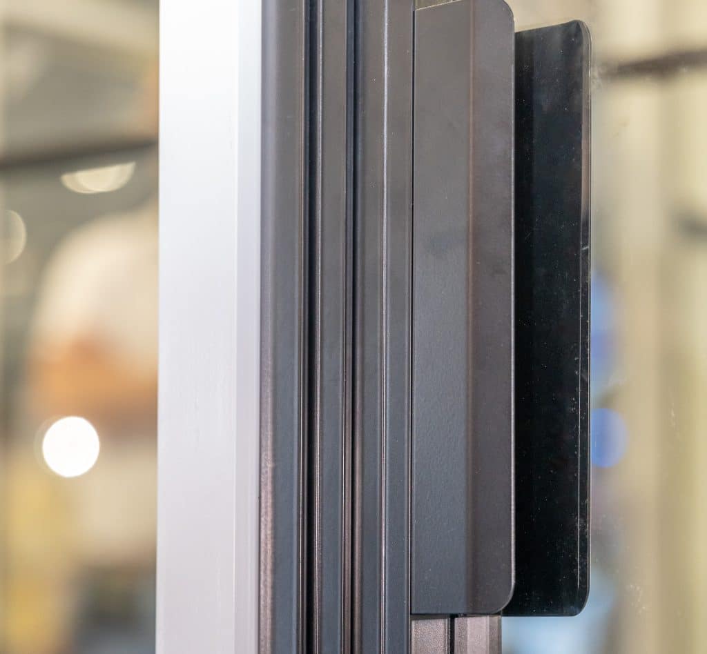 close up picture of black aluminium pad handle on an internal door
