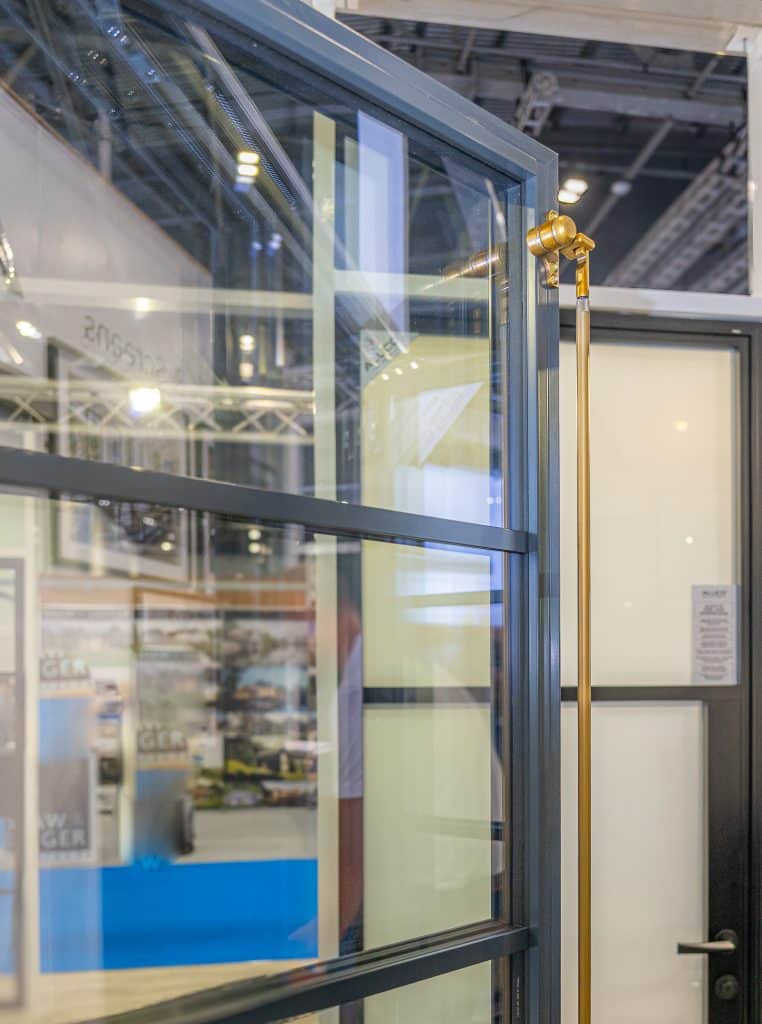 picture of period rod brass duplex handle on Aluco Elite window in an exhibition.