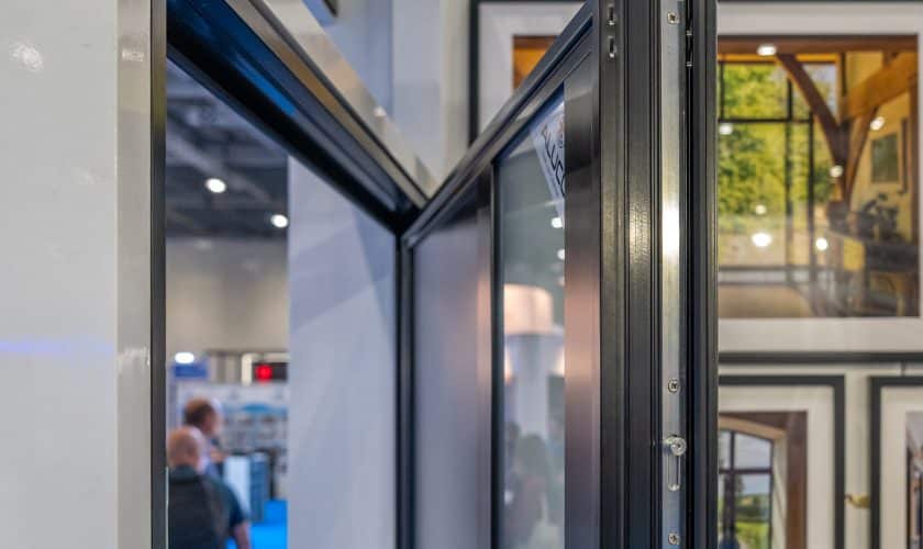 partially open aluco front door with pictures behind in an exhibition stand