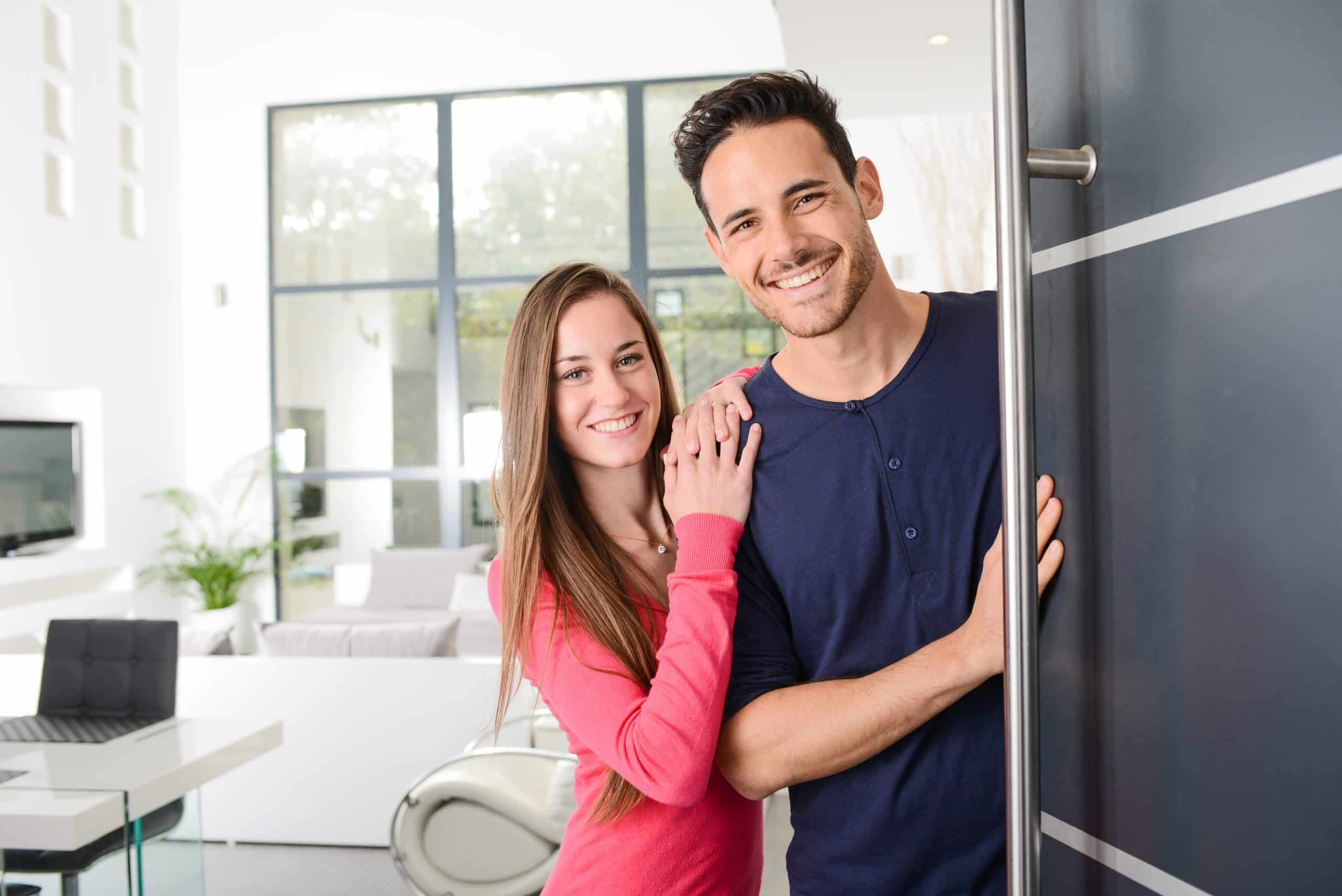 happy couple at their new open front door
