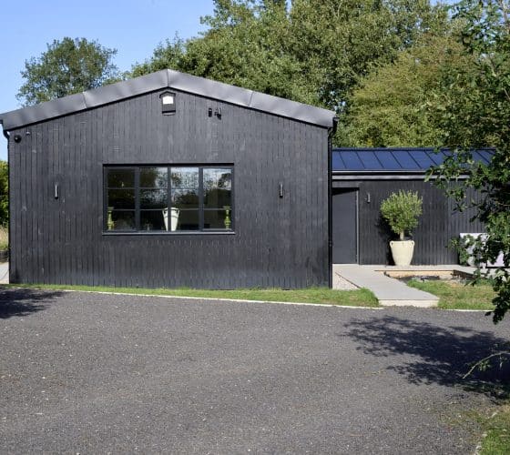 heritage windows and doors in devon barn conversion showing black cedar cladding lawn and aluco windows