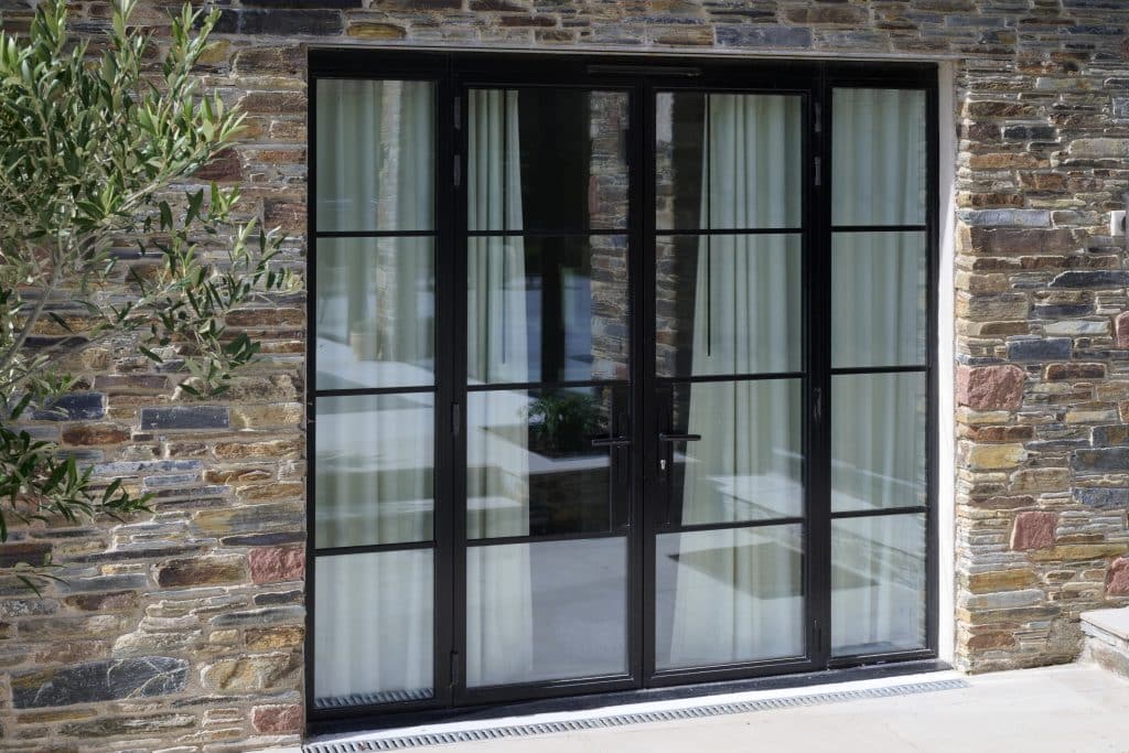 black heritage french doors and side panels in colour stonework